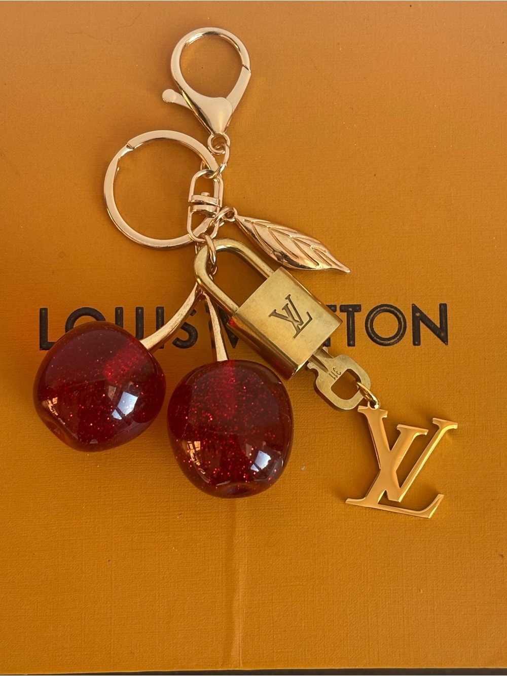 AUTHENTIC LOUIS VUITTON
BRASS LOCK & KEY #311, LARGE RED CHERRY BAG CHARM, 5.5β